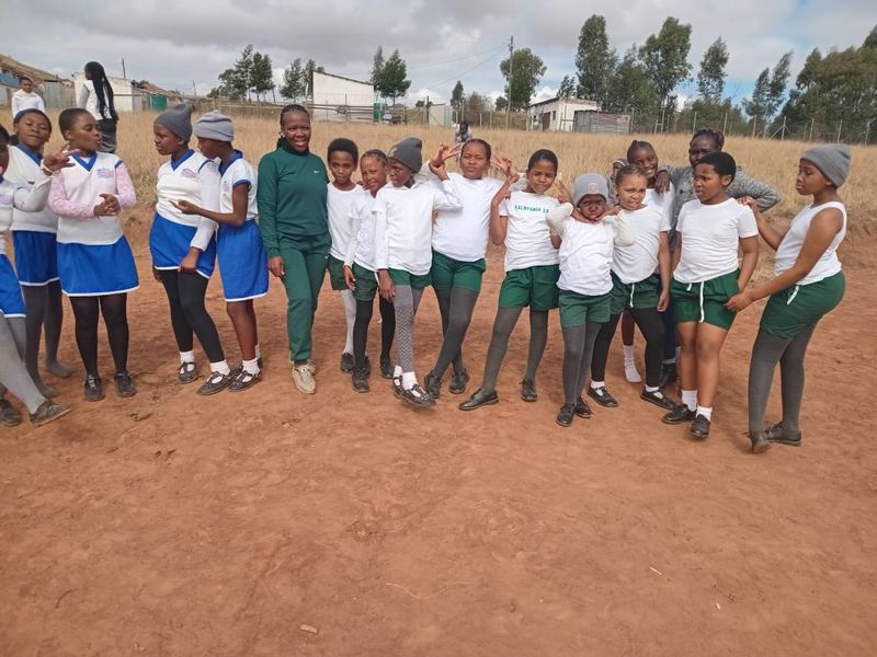 A Victory sports team lined up on the field in their kit